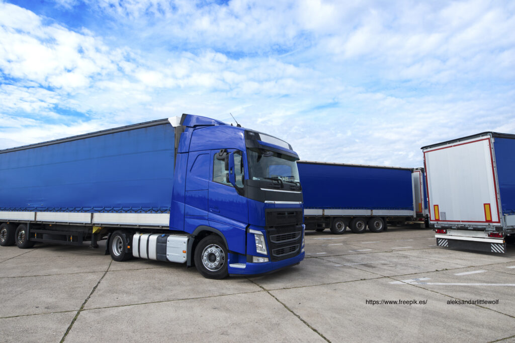 Truck vehicle with trailers in background.